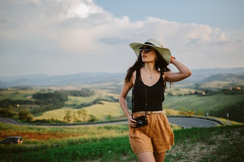Woman enjoys staycation in Italy, doing photography in Tuscany, taking photos of the beautiful sceni...