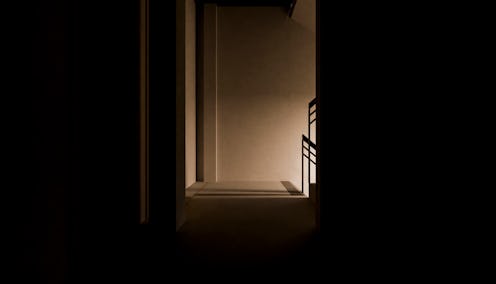 side view of stairs in the dark inside an apartment in a digital image without people around.