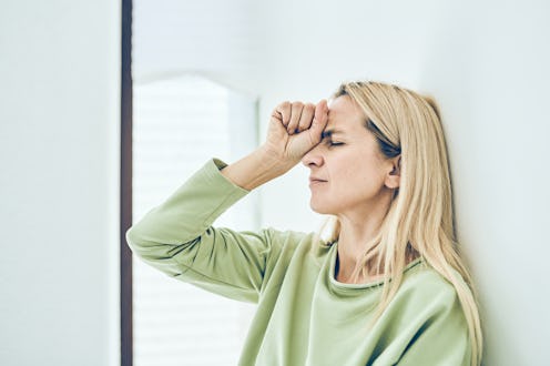 Depressive blonde woman. The concept of failure or headache.