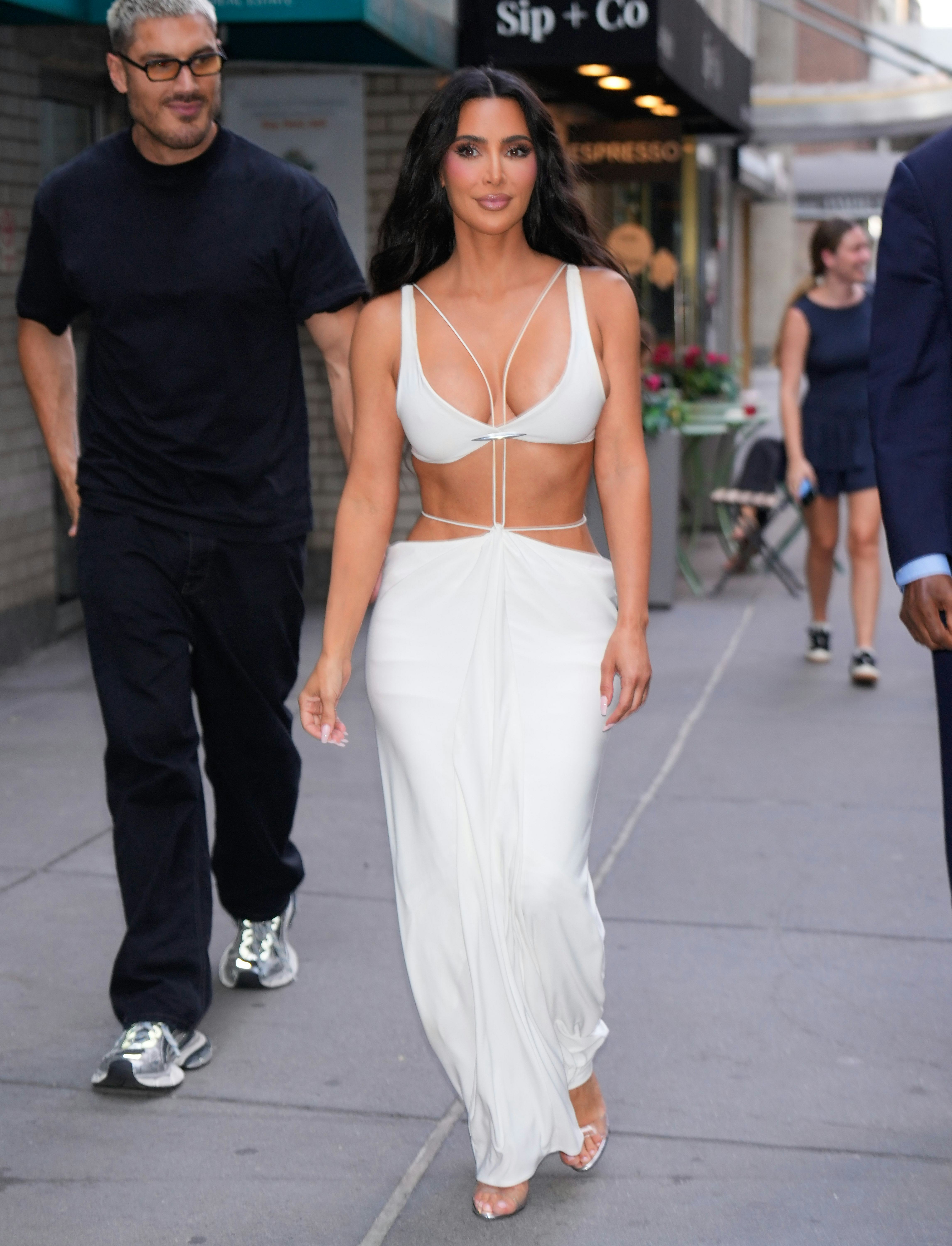 Kim Kardashian is seen in an all-white bra-and-skirt ensemble on August 14, 2024 in New York City.