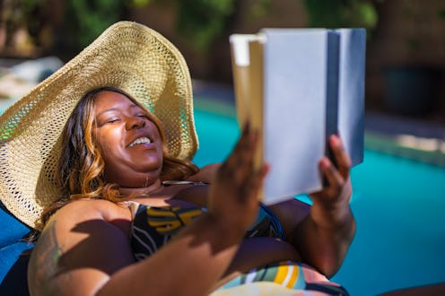 African American woman on vacation by the pool.