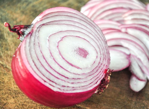 Red onions slice isolated on the cutting board.