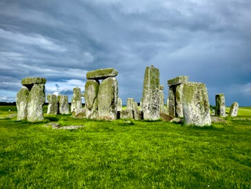 View of the famous and protected Stonehenge site from the ground floor during daytime featuring a co...