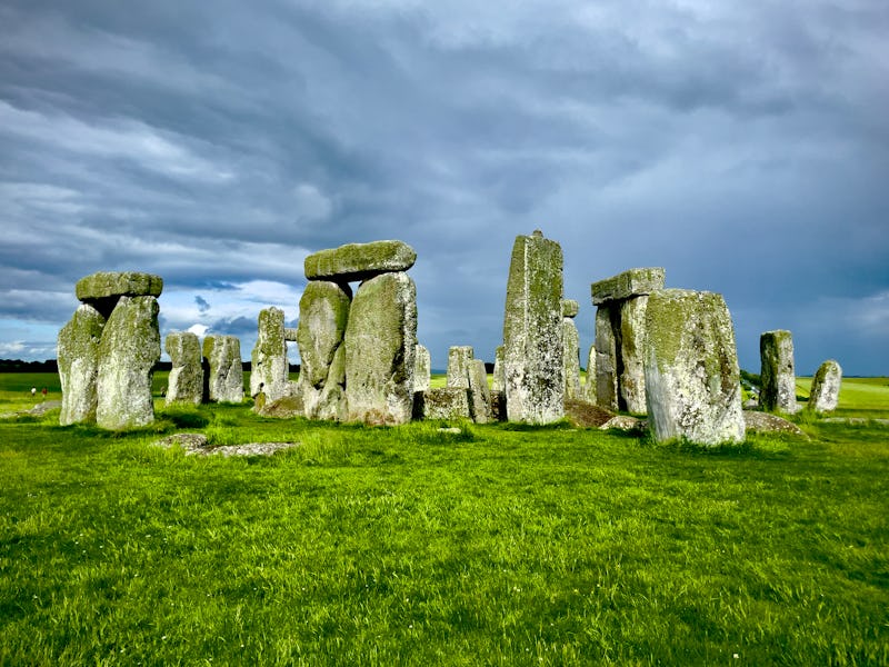 View of the famous and protected Stonehenge site from the ground floor during daytime featuring a co...