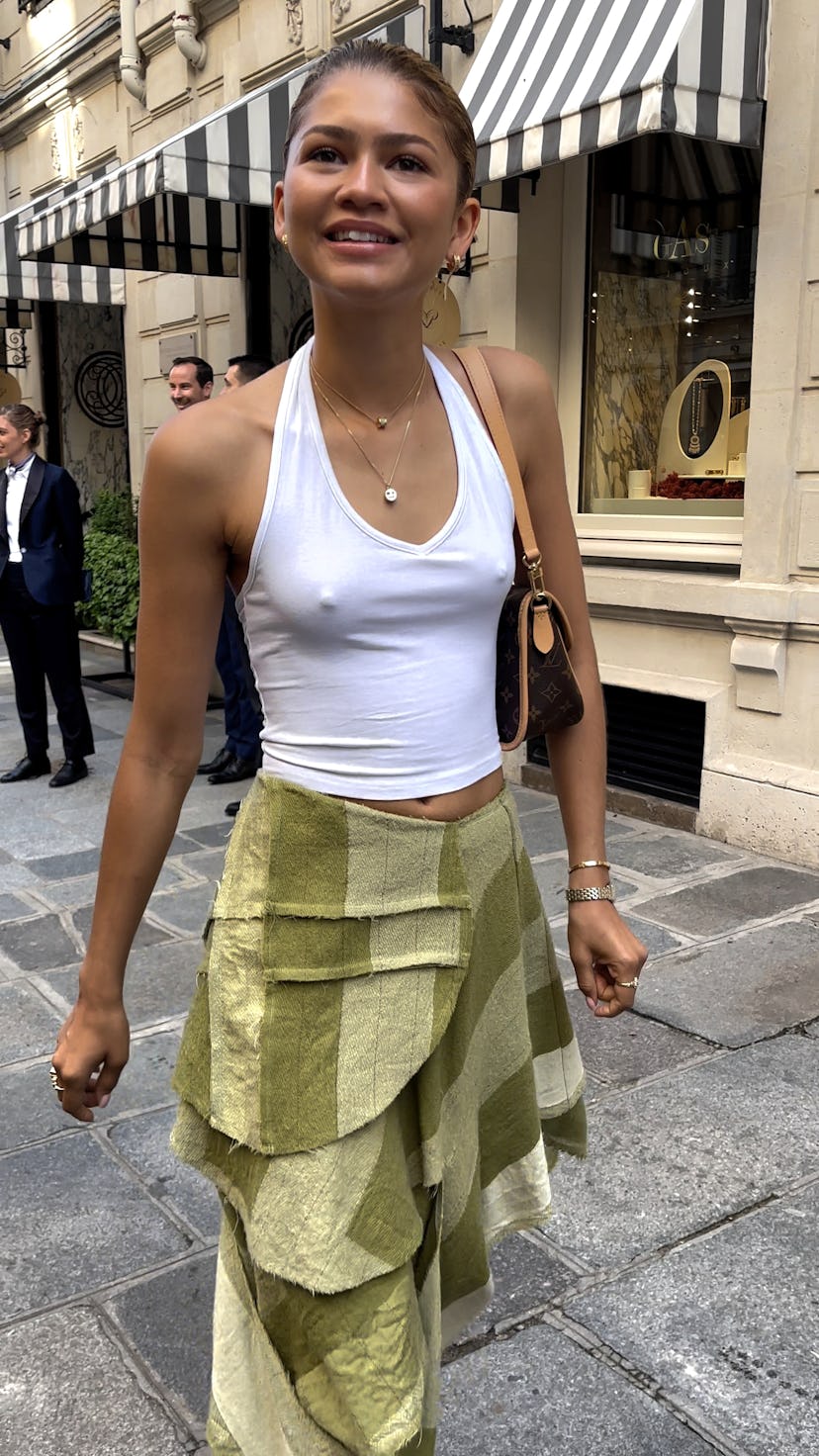 Zendaya wears a white halter top and green midi skirt on July 31, 2024 in Paris, France.