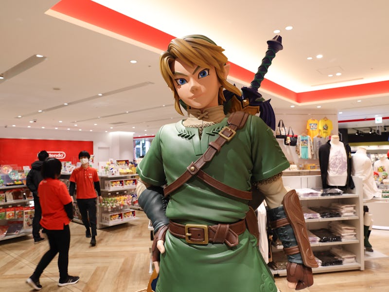 TOKYO, JAPAN - 2021/03/03: Link figurine from Legend of Zelda with shop staff inside Nintendo Tokyo ...