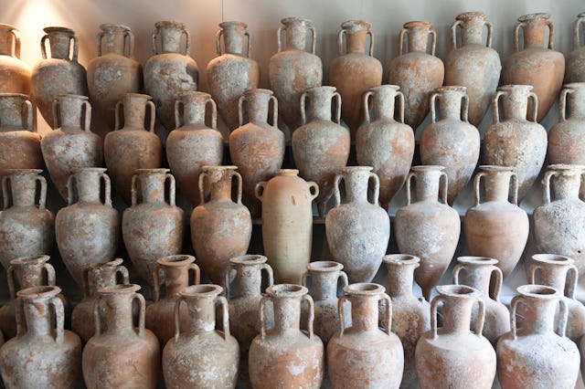 A collection of ancient jars arranged in a grid pattern.