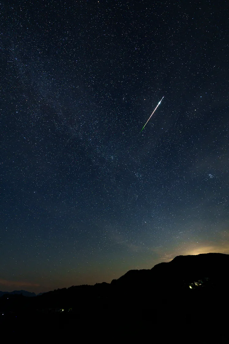 NANJING, CHINA - AUGUST 14: A meteor streaks across the sky during the Perseid meteor shower on Augu...