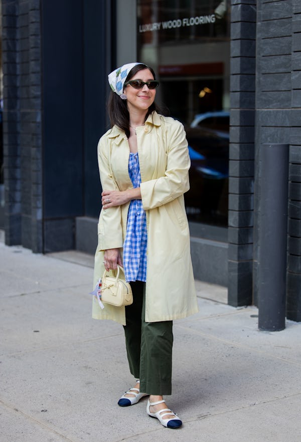 NEW YORK, NEW YORK - SEPTEMBER 08: A guest wears head scarf, yellow coat outside Sandy Liang New Yor…