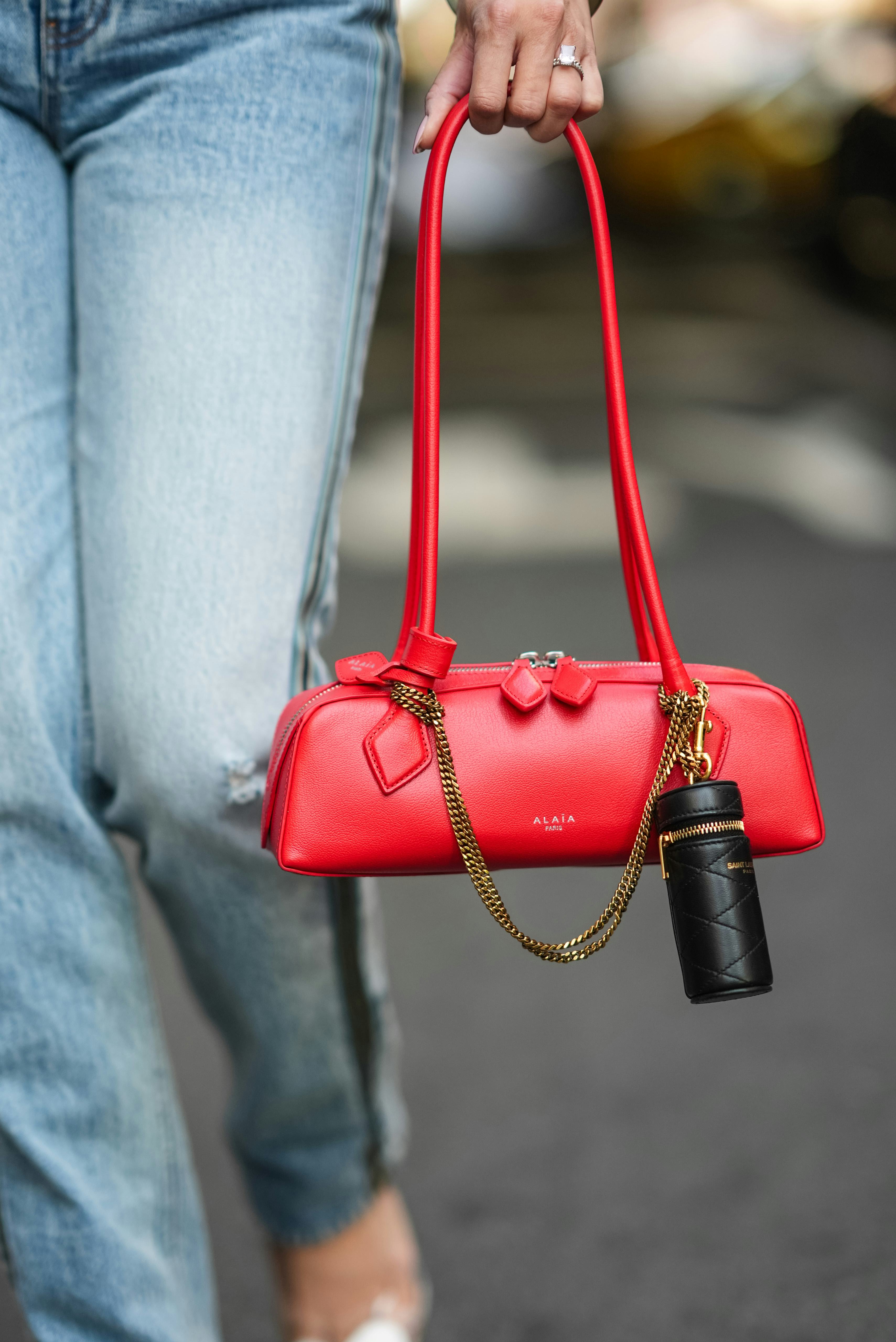 NEW YORK, NEW YORK - SEPTEMBER 09: Miki Cheung wears a shiny black leather bag, red leather bag from&hellip;