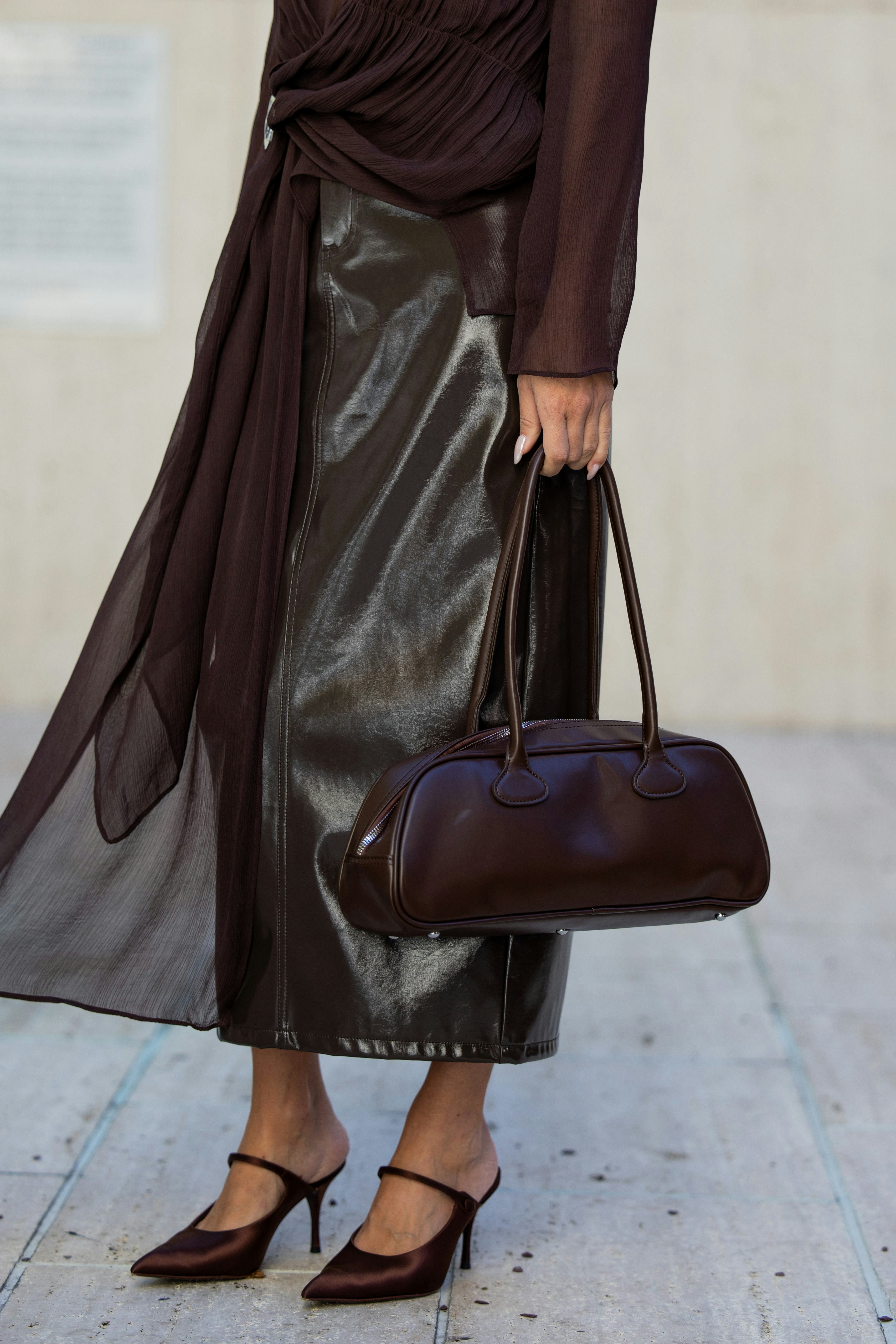 NEW YORK, NEW YORK - SEPTEMBER 10: Olga Sokolenko wears brown transparent top, vinyl skirt, bag, sun&hellip;