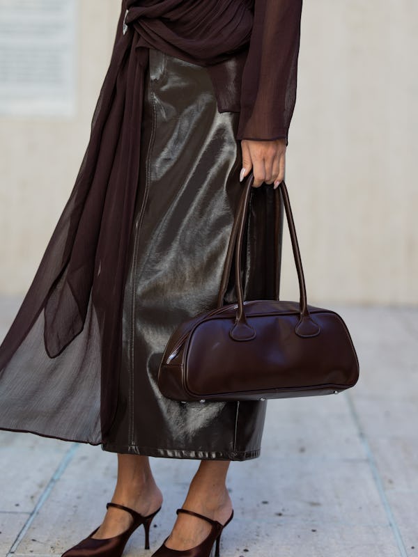 NEW YORK, NEW YORK - SEPTEMBER 10: Olga Sokolenko wears brown transparent top, vinyl skirt, bag, sun…