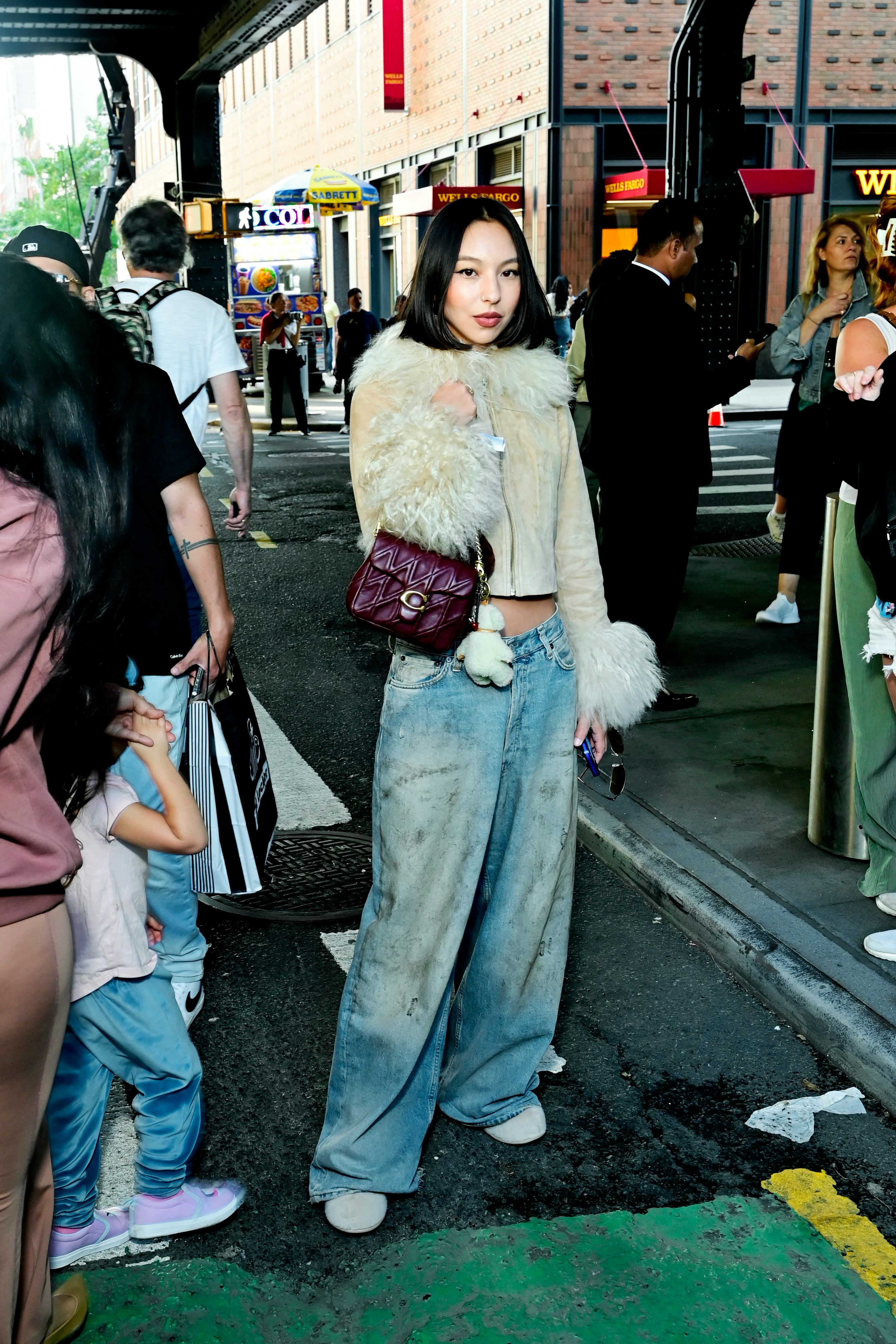 NEW YORK, NEW YORK - SEPTEMBER 09: A guest with a chin-length bob wears a beige suede cropped zip-fr&hellip;