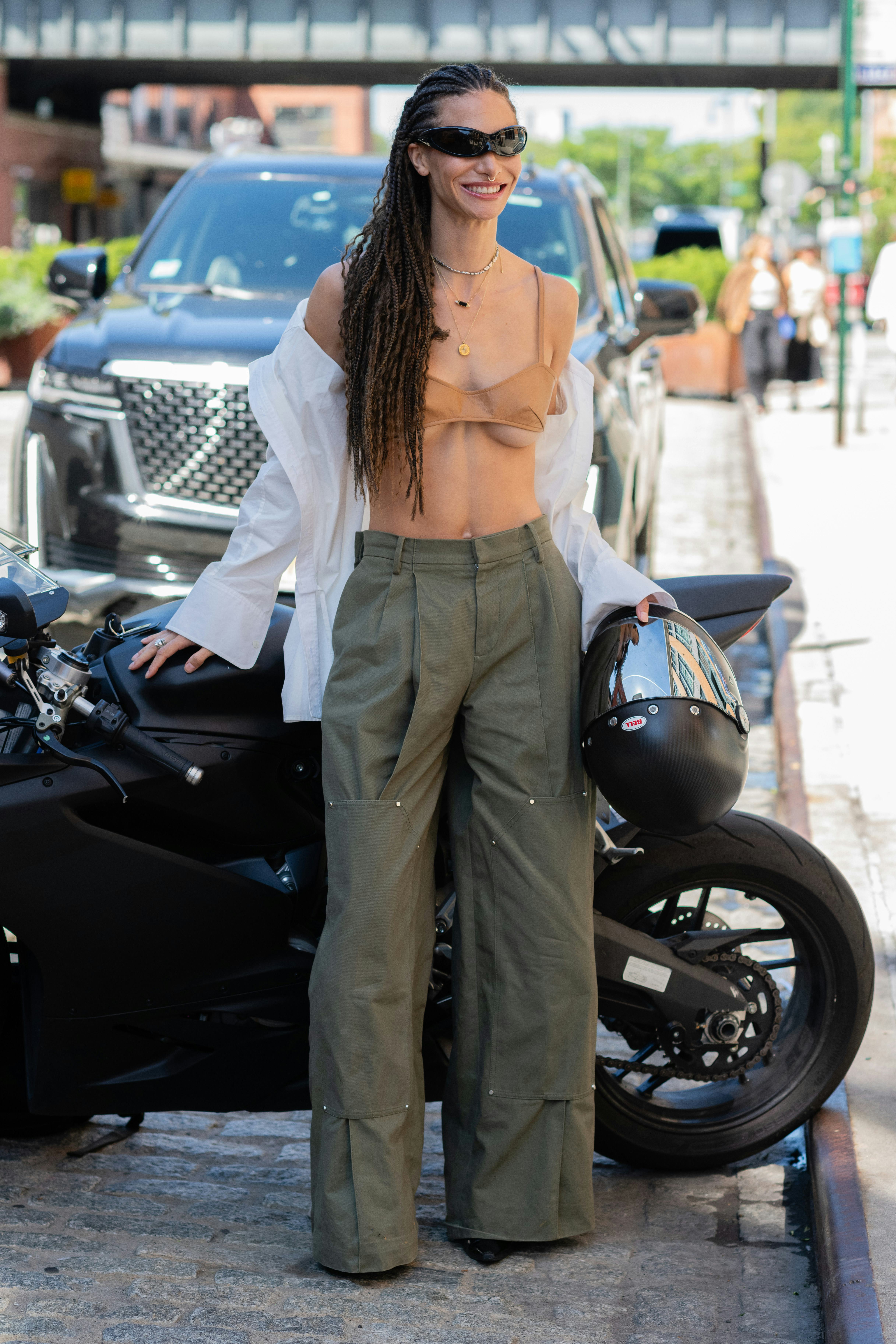 NEW YORK, NEW YORK - SEPTEMBER 11: A guest is seen wearing a tan top, green pant, white shirt, black&hellip;
