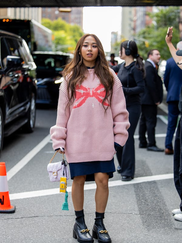 NEW YORK, NEW YORK - SEPTEMBER 09: MILLI wears pink knit, bag, skirt outside Coach during New York F…
