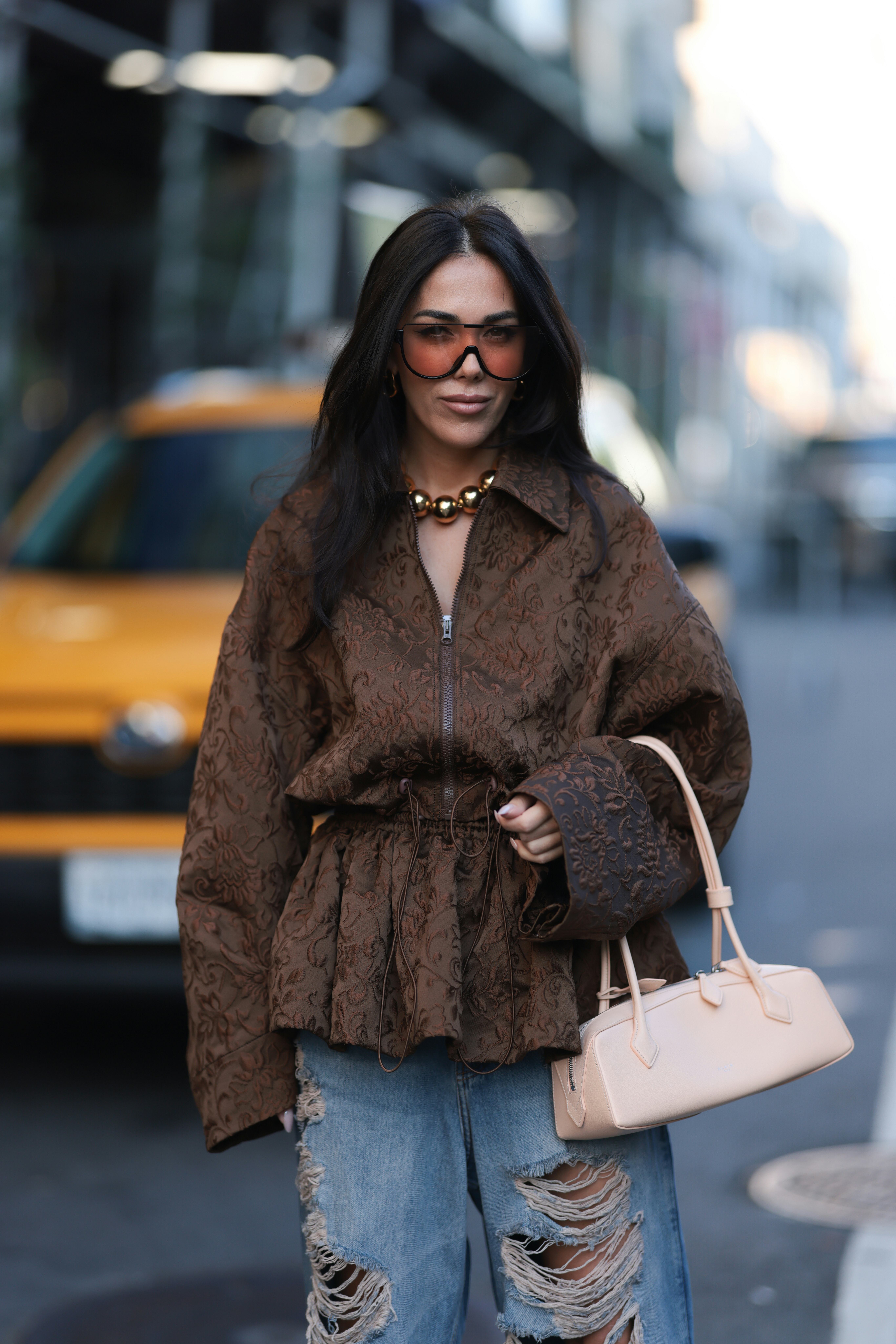 Olga Sokolenko seen wearing black sunglasses with orange sheer lenses, large gold pearl necklace, Ro&hellip;