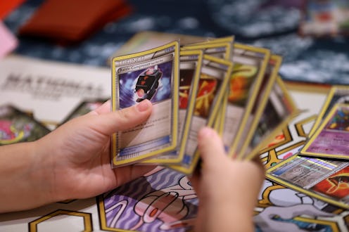 SAN FRANCISCO, CA - AUGUST 19: A contestant looks at cards as he competes during the 2016 Pokemon W...