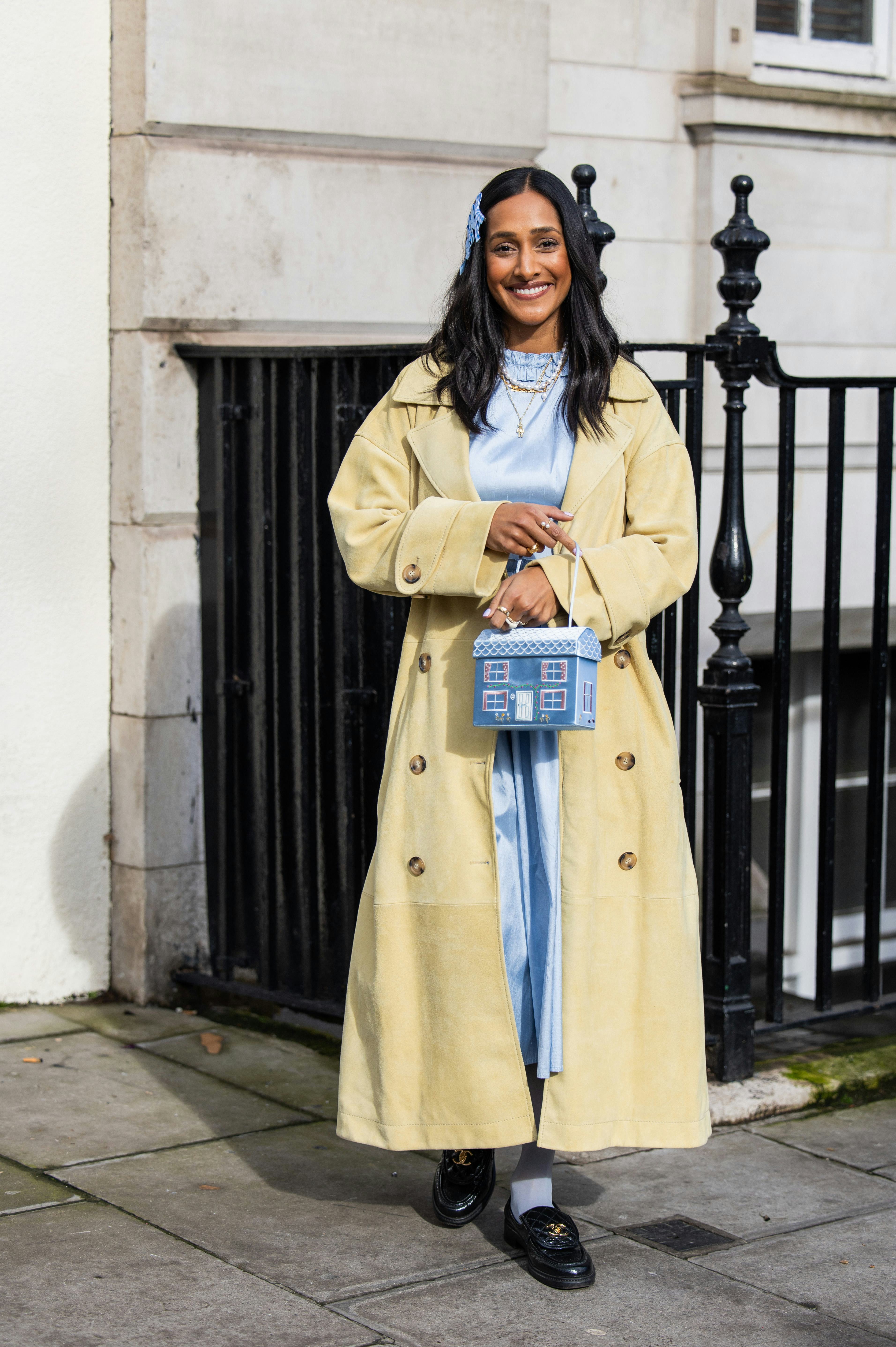 LONDON, ENGLAND - FEBRUARY 18: Zeena Shah wears blue bows in hair, blue dress, pearl necklace, beige&hellip;