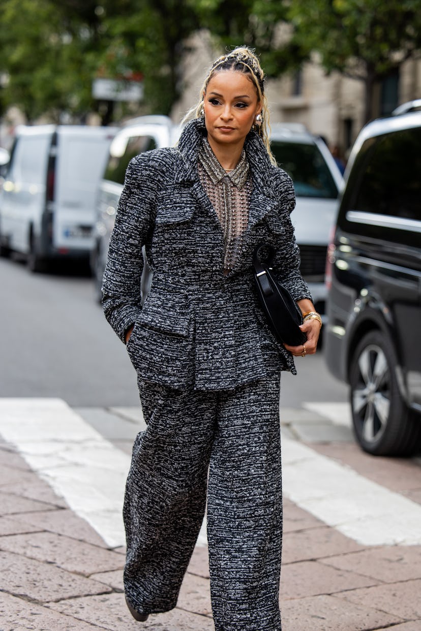 MILAN, ITALY - SEPTEMBER 17: Sai De Silva wears grey jacket, pants, black bag outside Alberta Ferret...