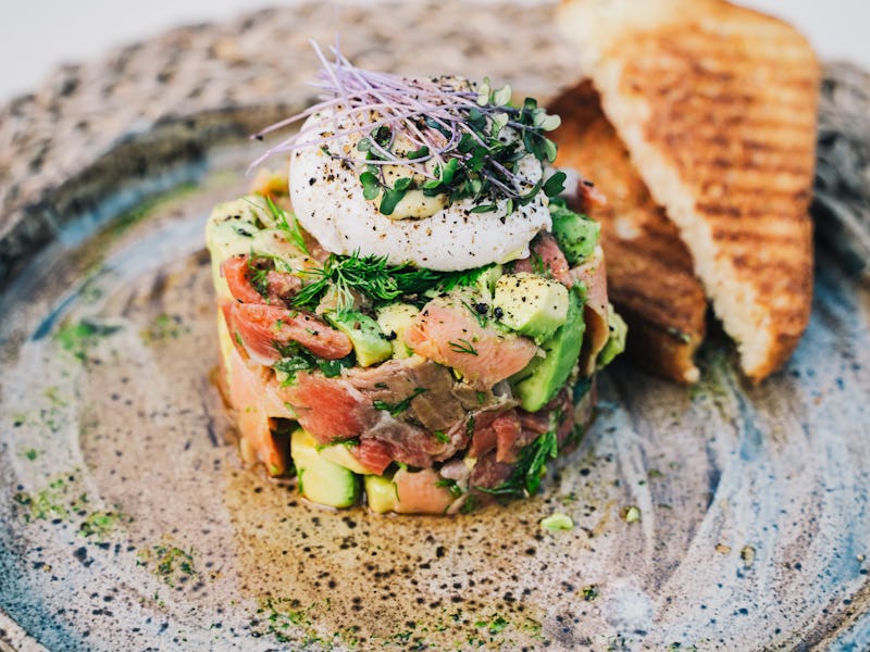 Salad with avocado and salmon, restaurant serve, close-up