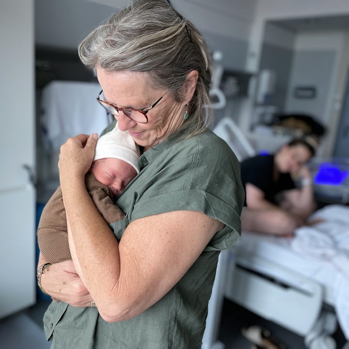 Supportive mother in law in the delivery room with daughter in law.