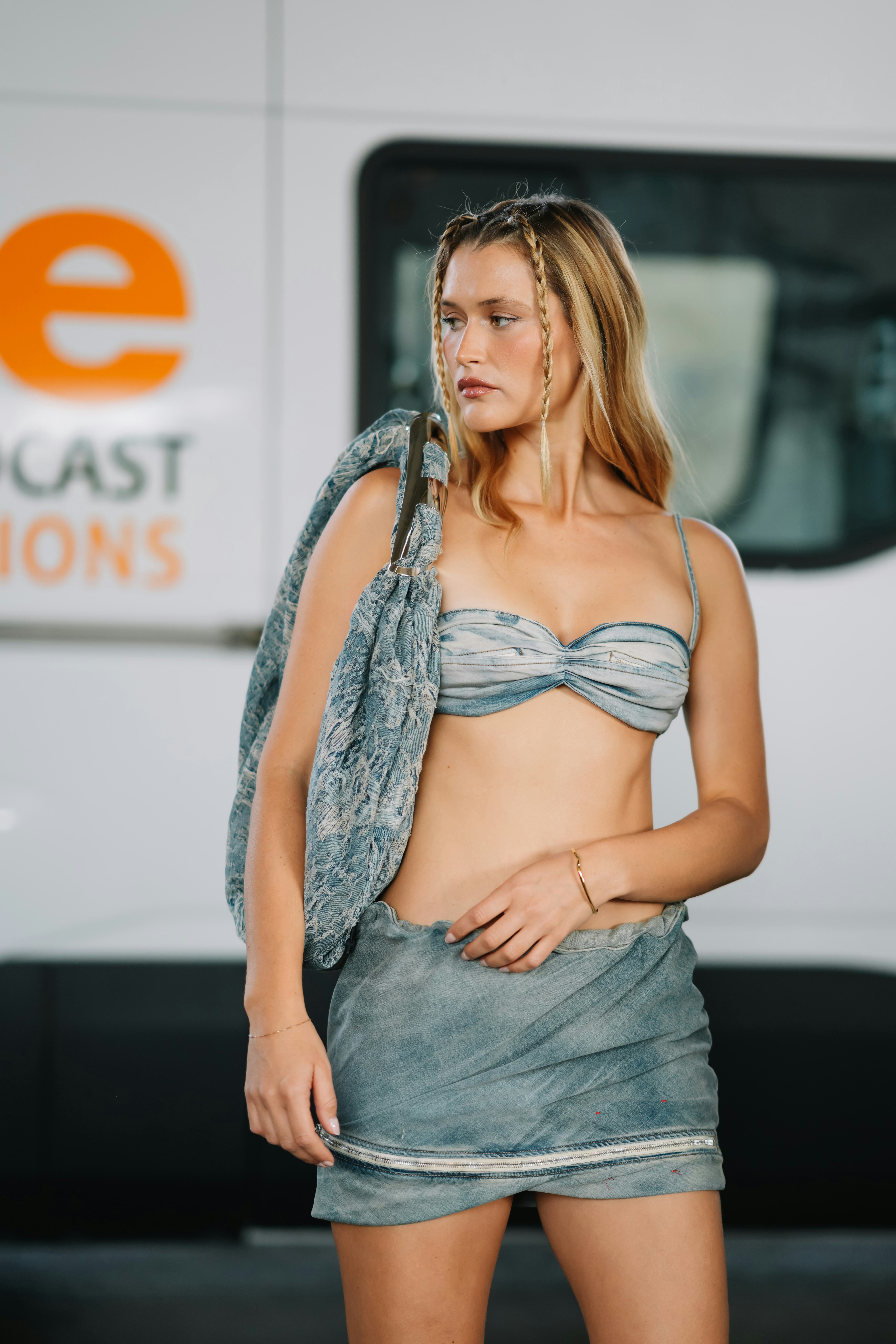 MILAN, ITALY - SEPTEMBER 21: Chloe Lecareux wearing a denim bandeau top and matching mini skirt, a l&hellip;