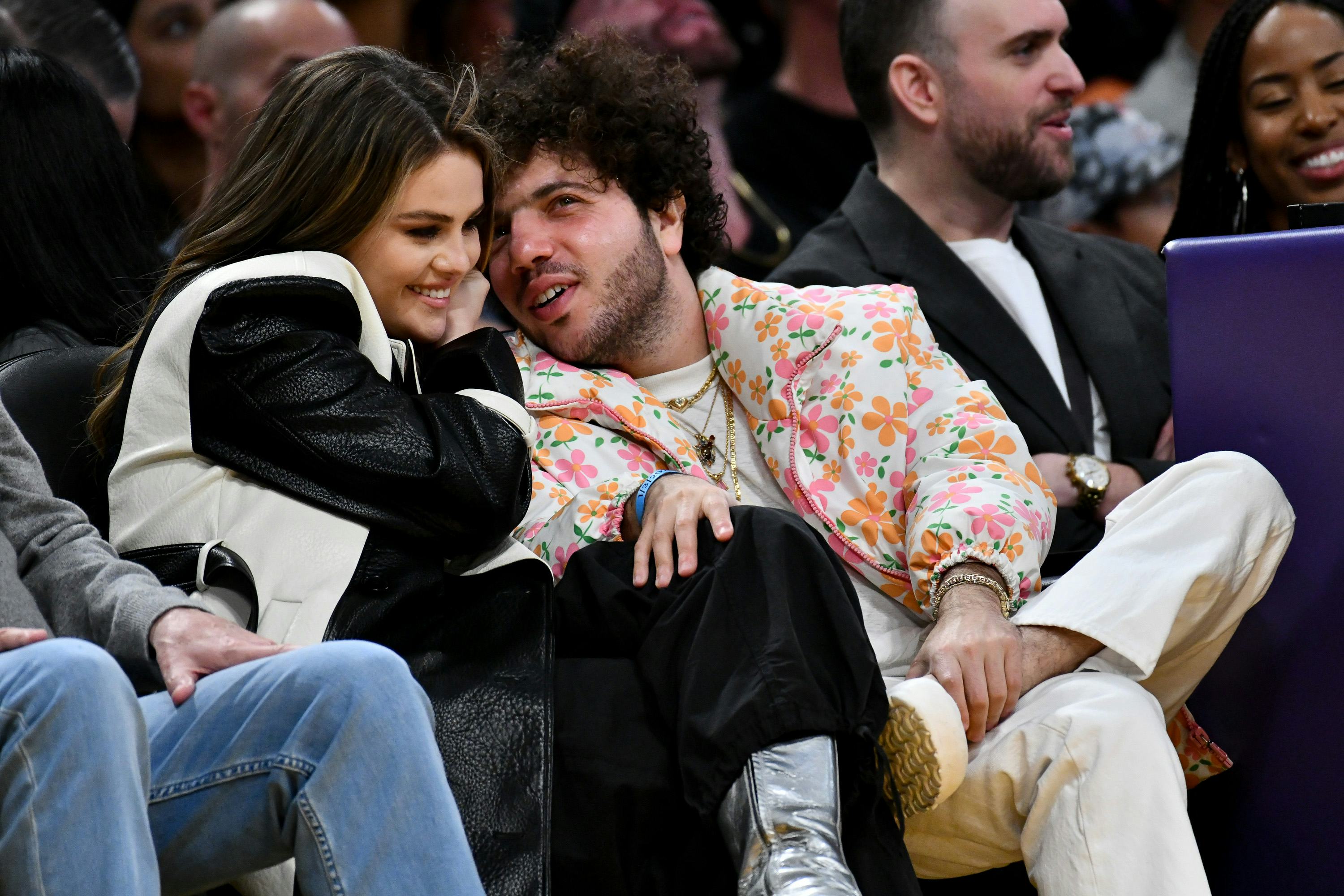 LOS ANGELES, CALIFORNIA - JANUARY 03: Selena Gomez and Benny Blanco attend a basketball game between...