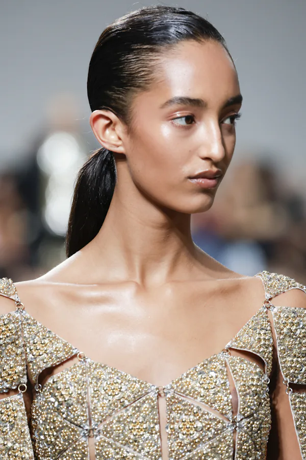 Glossy peach-tinted eyelids were spotted at Paris Fashion Week Spring/Summer 2025.