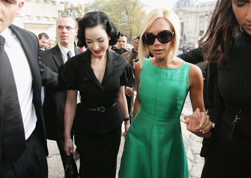 Victoria Beckham (R) and Dita Von Teese (L) at the Chanel Fashion show during the Paris Fashion Week...