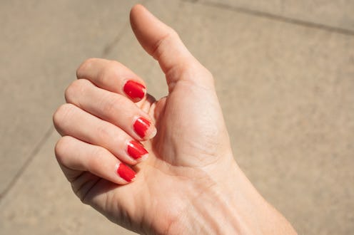 Chipped nails personal perspective fingernails, woman's hand with chipped nail polish. concept of pe...