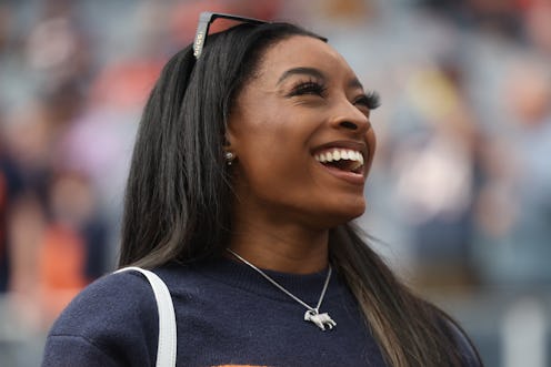 CHICAGO, ILLINOIS - SEPTEMBER 29: Gymnast Simone Biles stands on the sideline before the football ga...