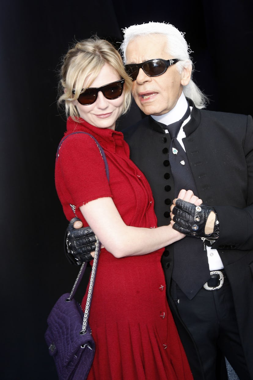 Kirsten Dunst and Karl Lagerfeld attend the Chanel fashion show during the Spring/Summer 2008 ready-...