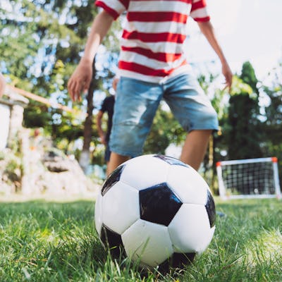 Kids playing an informal game of soccer. Residents in a small neighborhood say that their HOA is demanding that kids don't play sports in the common areas.