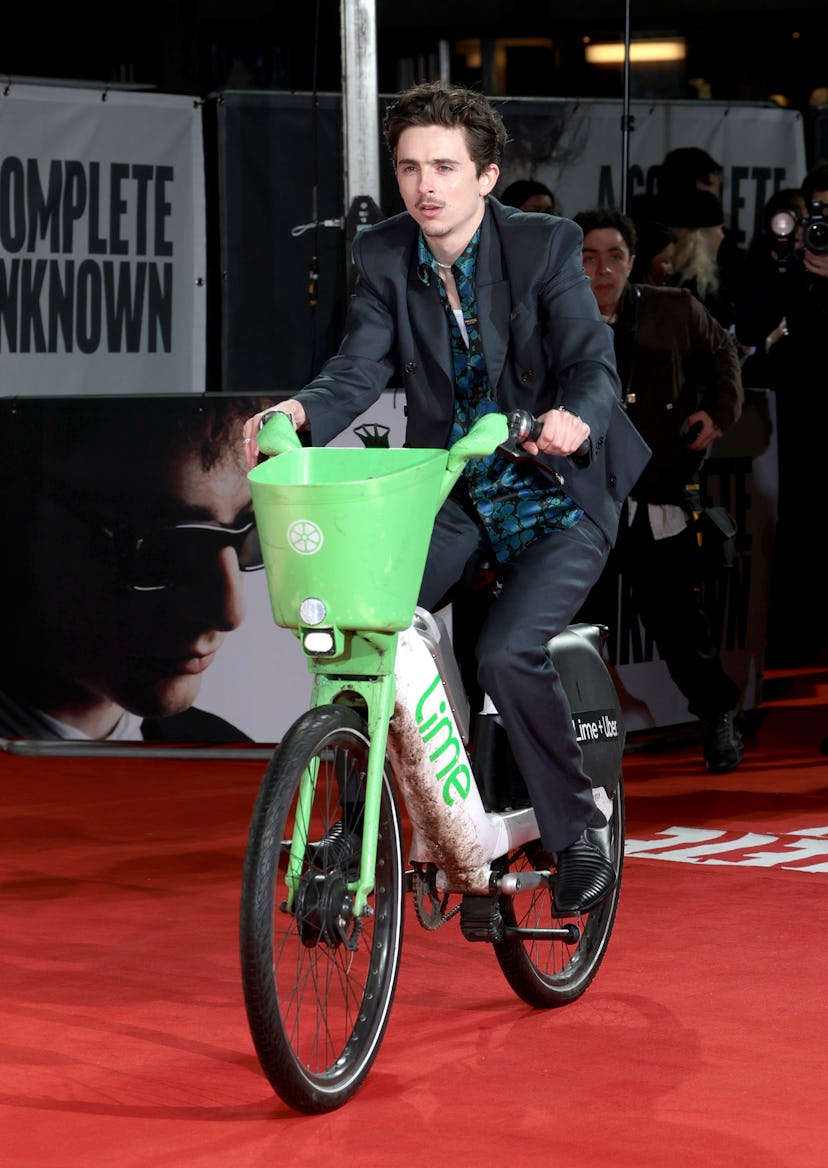 LONDON, ENGLAND - JANUARY 14: Timothée Chalamet rides a Lime Bike as he attends the UK Premiere of "...