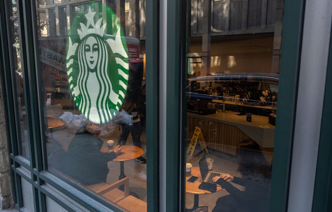 NEW YORK, NEW YORK - JANUARY 14: A person uses a laptop inside of a Starbucks on January 14, 2025 in...