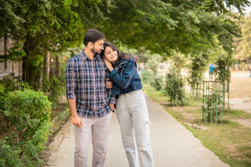 Cheerful Asian/ indian loving, romantic young couple spending leisure time together and enjoying fre...