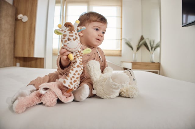 Beautiful baby girl with her toys.
