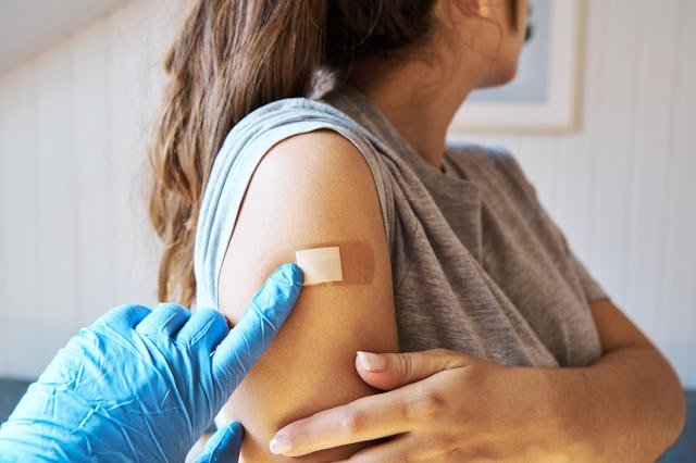 Close up view of a woman getting vaccinated against Covid-19. Medicine and vaccination concept.