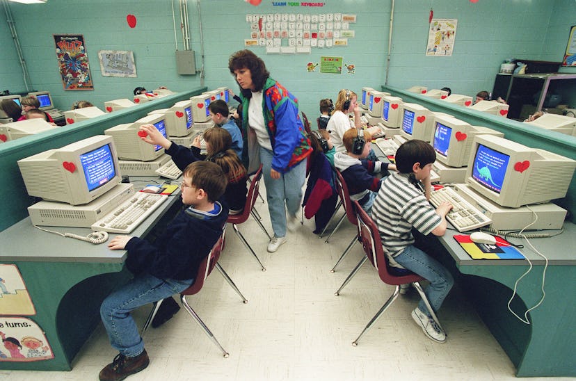 UNITED STATES - FEBRUARY 18:  EDUCATION--Teacher's aide Carole Marcum looks over the shoulders of st...