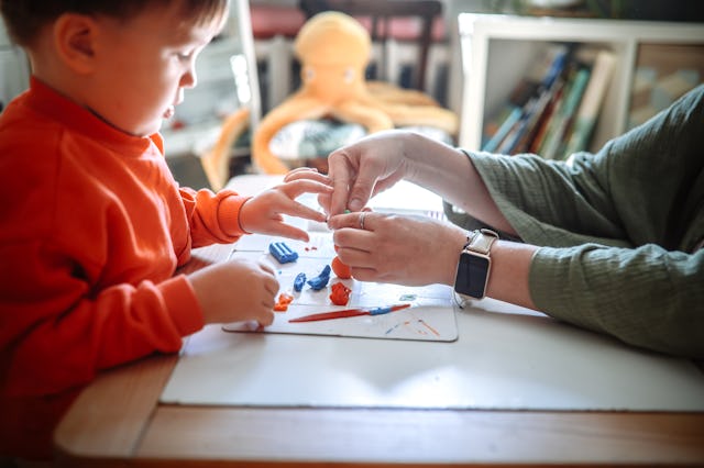 Mom sculpting with toddler, close-up and soft light, early development and fine motor skills