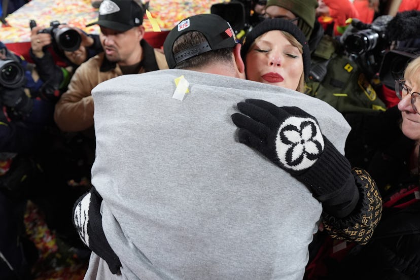 Travis Kelce #87 of the Kansas City Chiefs and Taylor Swift celebrate a win in the AFC championship …