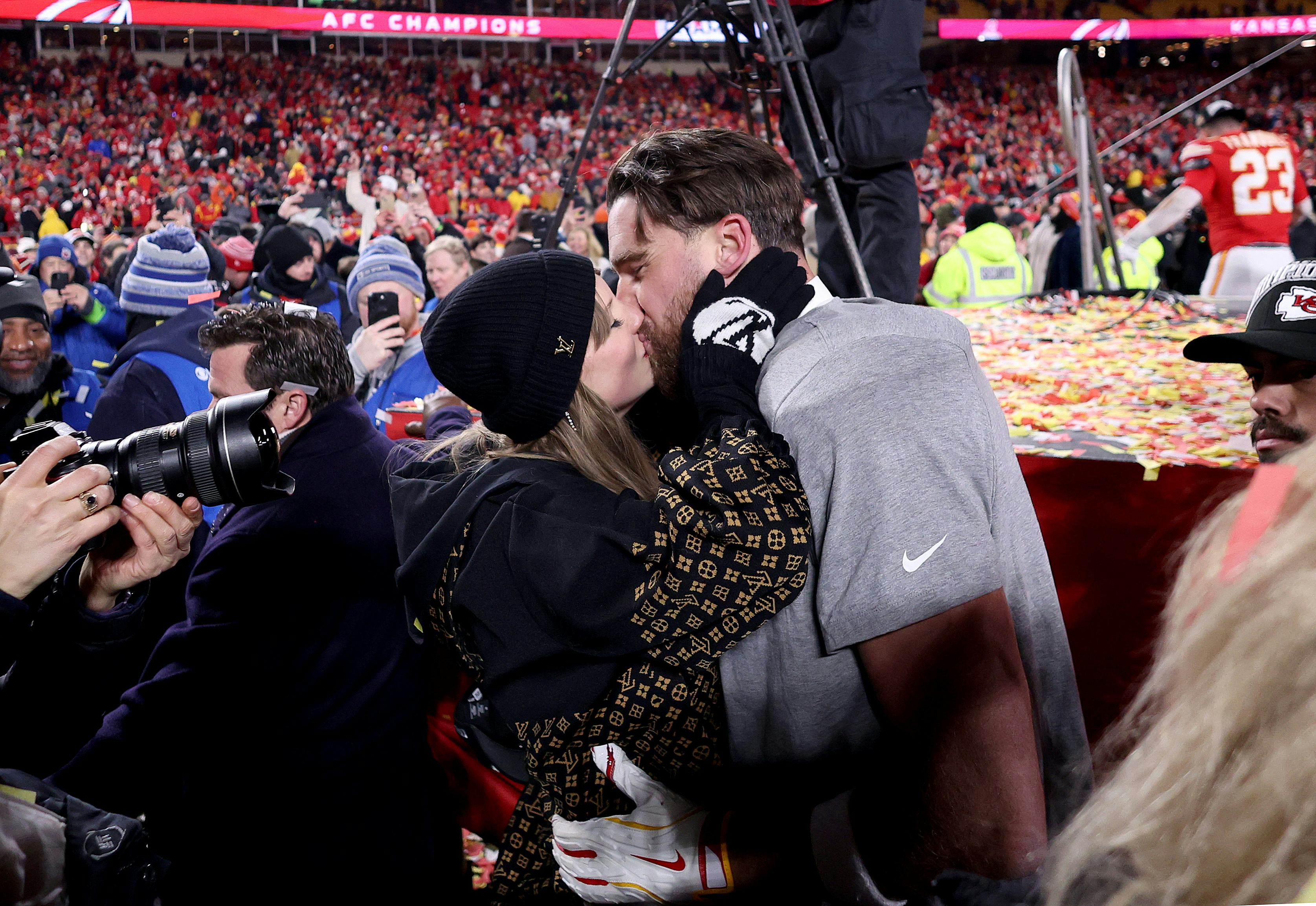 Taylor Swift kisses Travis Kelce of the Kansas City Chiefs at the AFC Championship Game