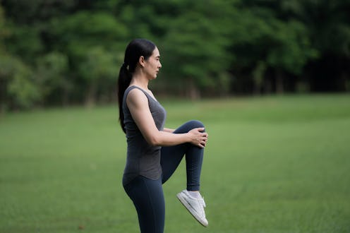 Asia woman wearing sportswear is doing administrative exercises in the park.