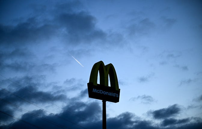 An airline jet flies past the logo on a restaurant of US fastfood chain McDonald's in Hanau, western...