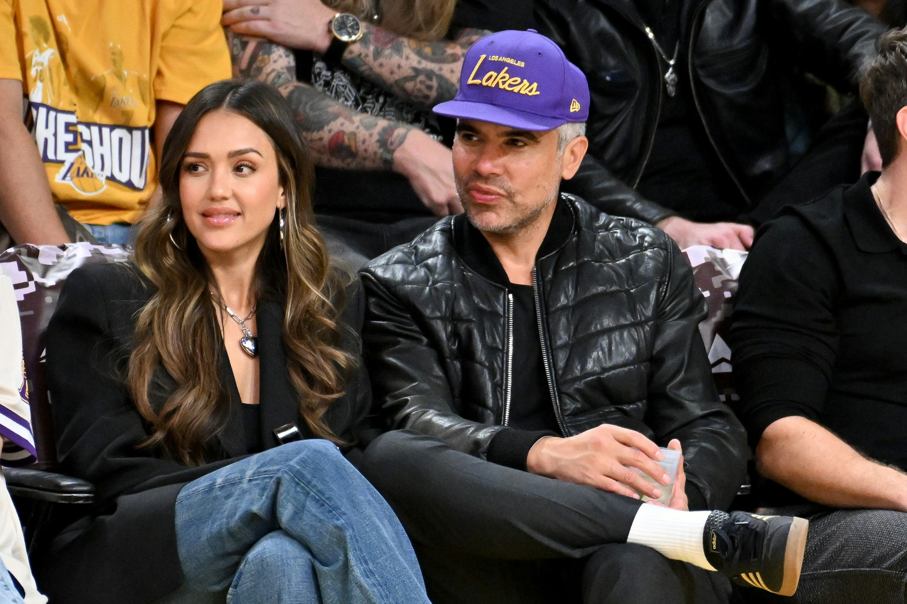 Jessica Alba and Cash Warren attend a basketball game