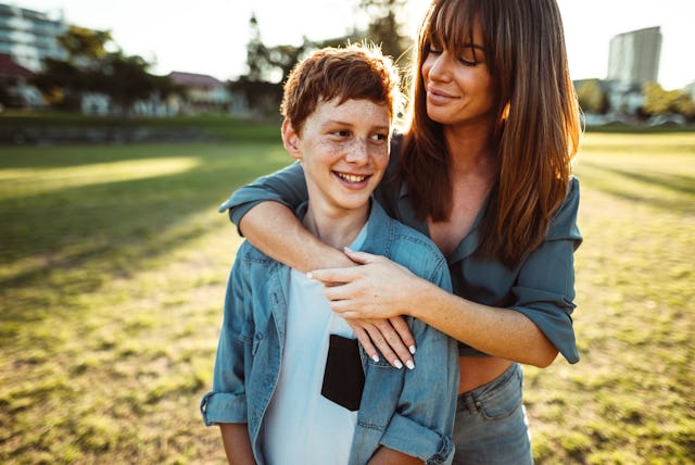 teenager embraced with mom consoling her son