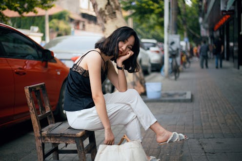 A young Asian woman traveling in the city