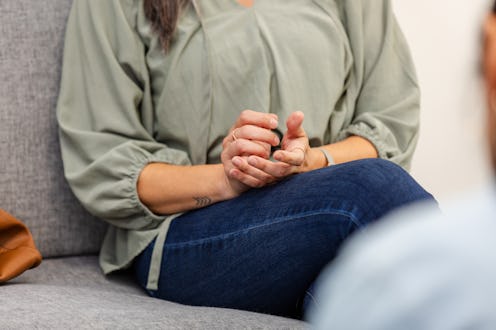 Close-up of a woman's hands during a therapy session, conveying emotional support.