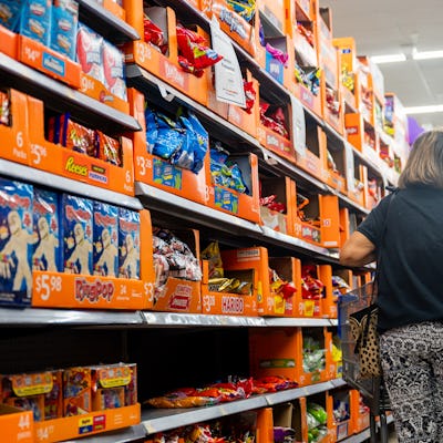AUSTIN, TEXAS - OCTOBER 16: A customer shops for Halloween candy at a Walmart Supercenter on October 16, 2024 in Austin, Texas. Due in part to a shortage of cocoa beans, Halloween candy prices are on the rise this year as chocolate prices have climbed 7.5%. Candy companies have begun shifting to non-chocolate candies as chocolate makers deal with shrinking margins and a decrease in sales. (Photo by Brandon Bell/Getty Images)