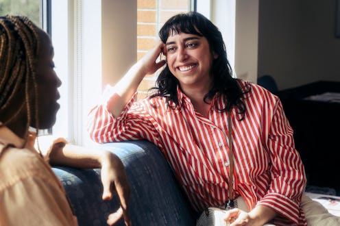 Female friends talking while waiting for appointment at doctor's office.